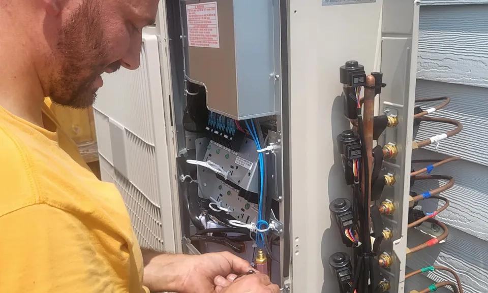 MH HVAC technician servicing a system in a Worth, IL home