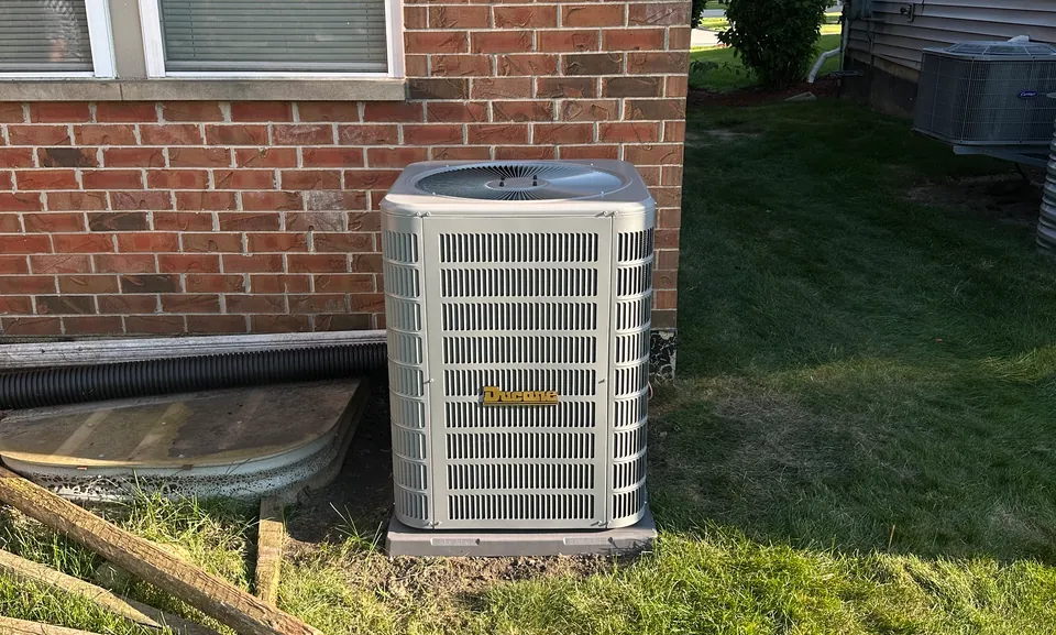 Central air conditioning condenser outside a Worth, IL home