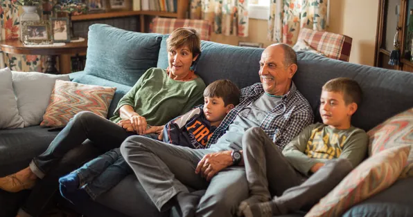 Family relaxing together on a living room couch