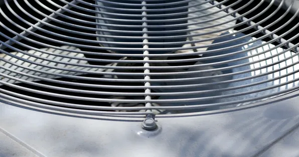 Close-up of an air conditioner condenser fan grille