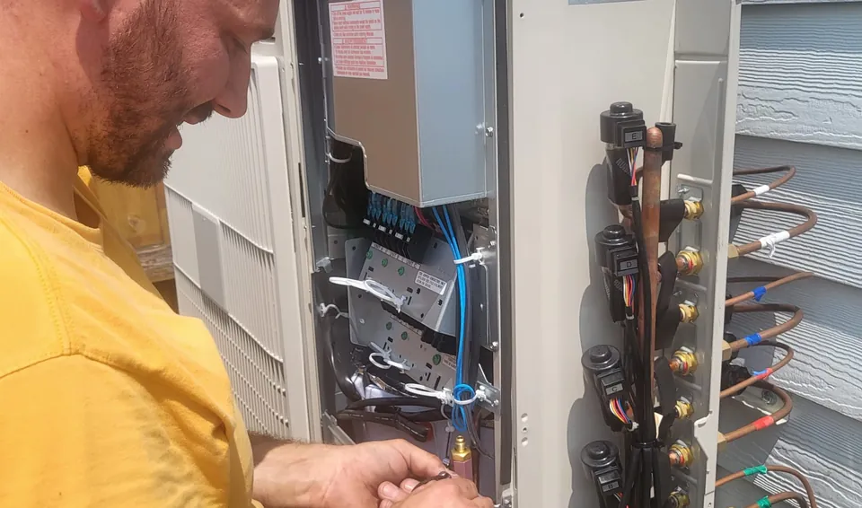 MH HVAC technician charging a system during a service call